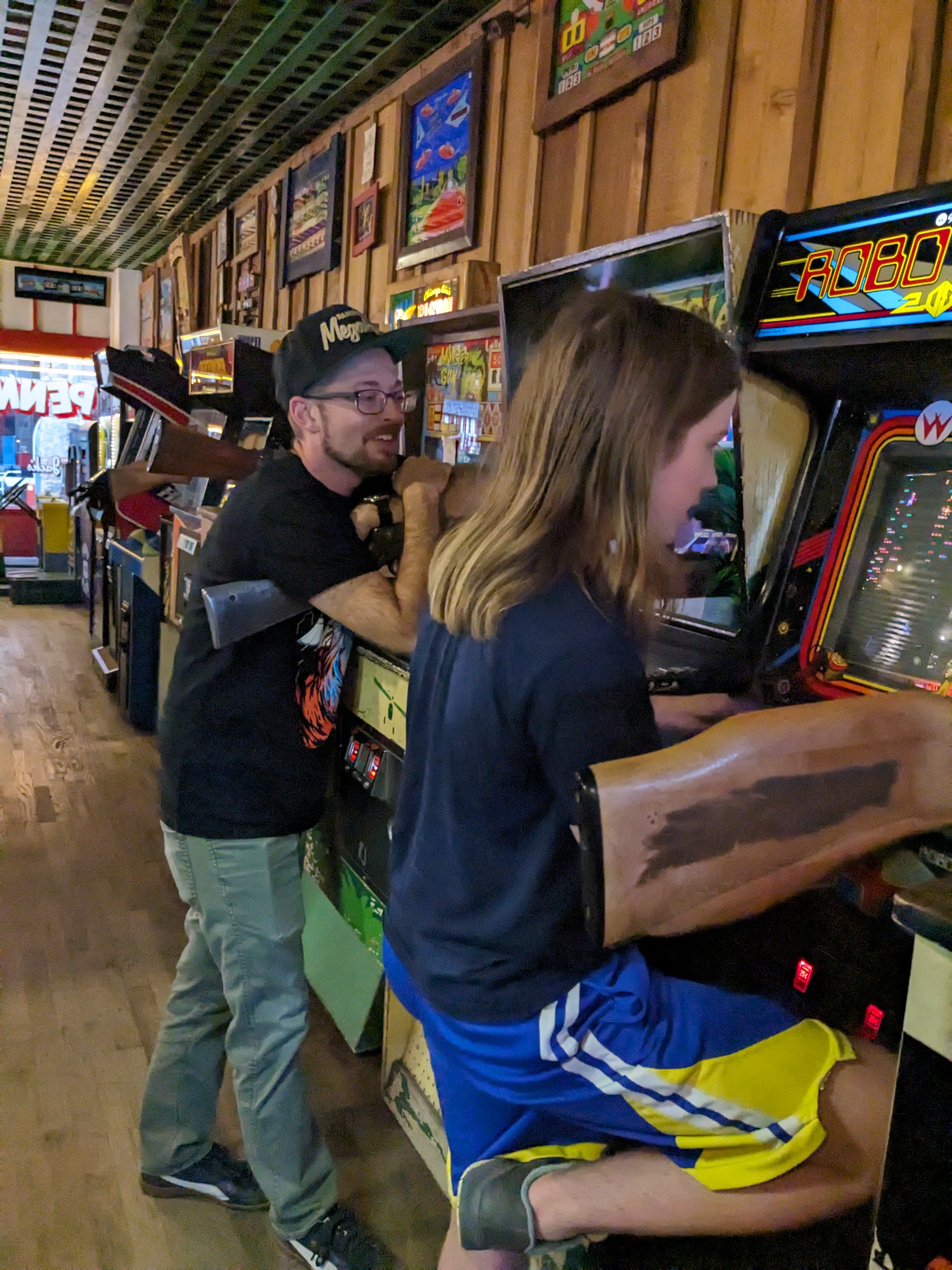 Alex and Silas playing a shooting arcade game