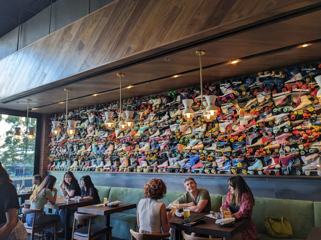 The wall of a wine bar, with probably a couple hundred rollerskates mounted on it.